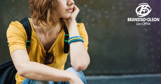 Depressed teen girl with left hand on her face